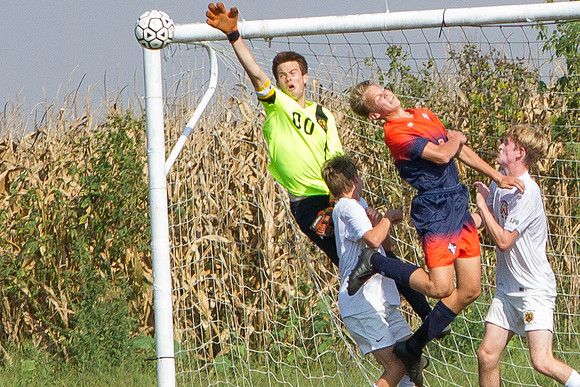 Jarrett Brunner heads the ball on goal against STM